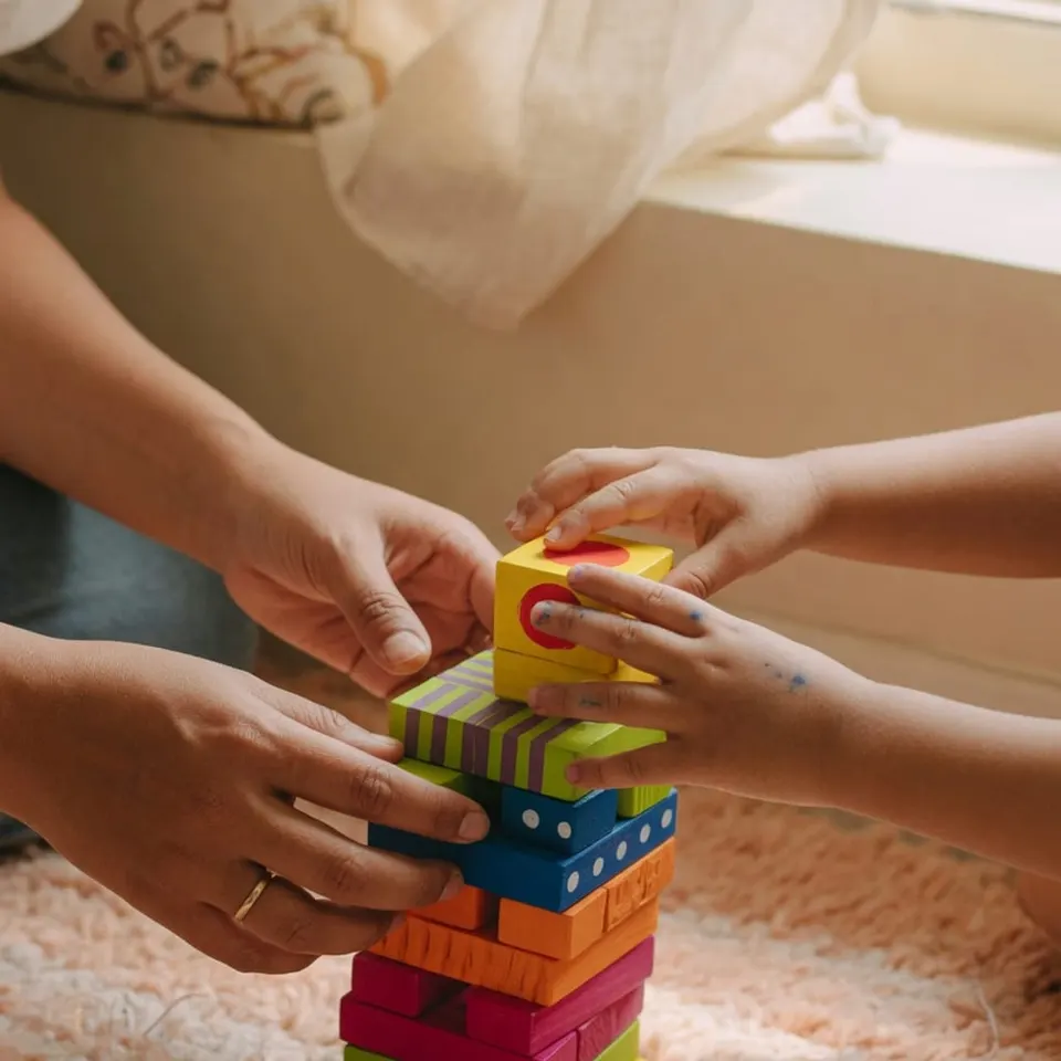 A child stacking colorful blocks during play — Liftoff ABA in Gloucester County